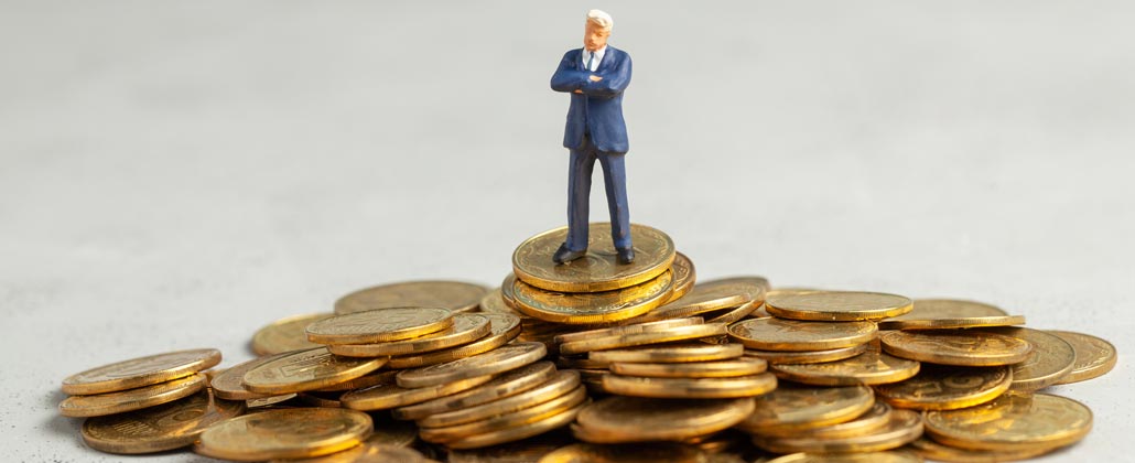 Figura de um homem em cima de moedas